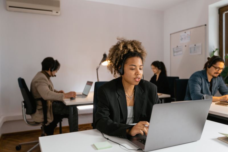 woman sitting on laptop in office